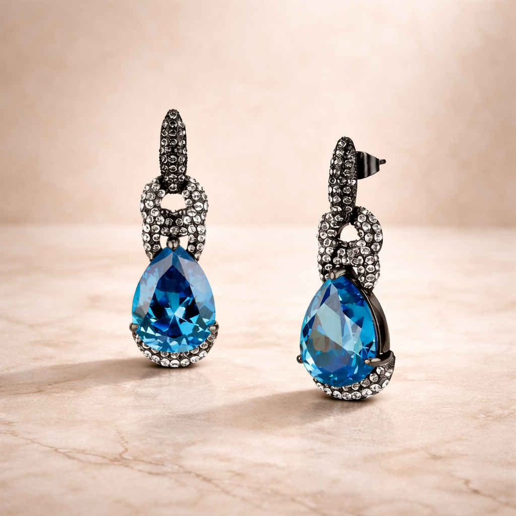 Black leather ankle boot with block heel and silver chain detail on an editorial studio background